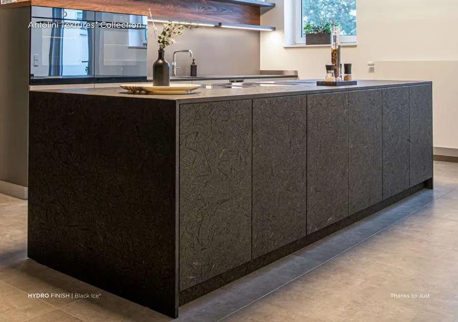 Antolini Black Ice granite in Hydro Finish, dark charcoal field with silver mineral flecks, kitchen island install