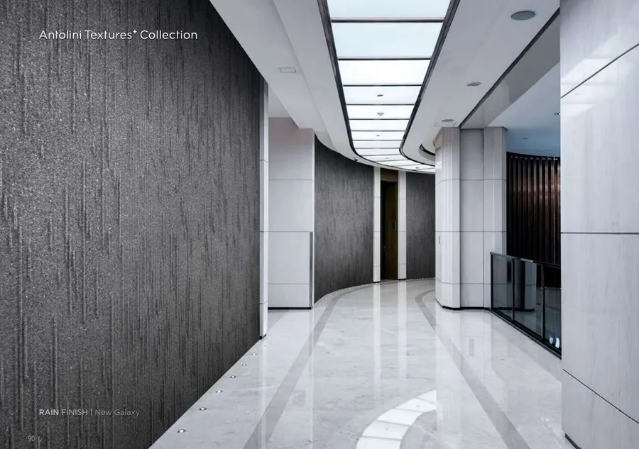 Antolini New Galaxy granite in Rain Finish, deep grey-black with mineral flecks, corporate corridor install