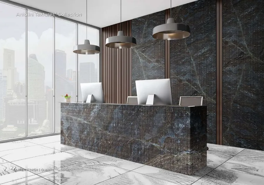 Antolini Quarzite Madeirus quartzite in Linen Finish, deep grey-blue field with copper veining, reception desk install
