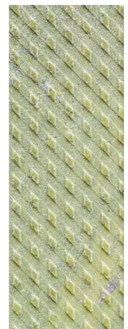 Metal finish on Antolini Irish Green — raised coin-cell grid