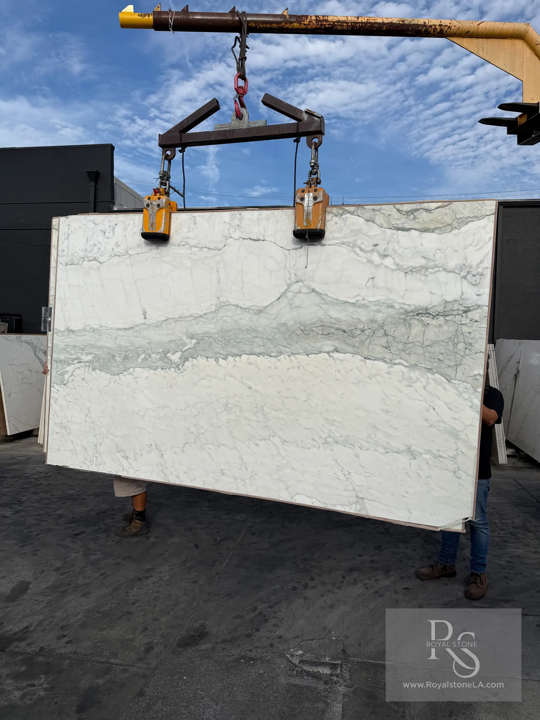 Antolini Calacatta Breccia Turquoise Light YG556 marble slab on the crane at the Royal Stone yard, white field crossed by a band of soft turquoise and green breccia