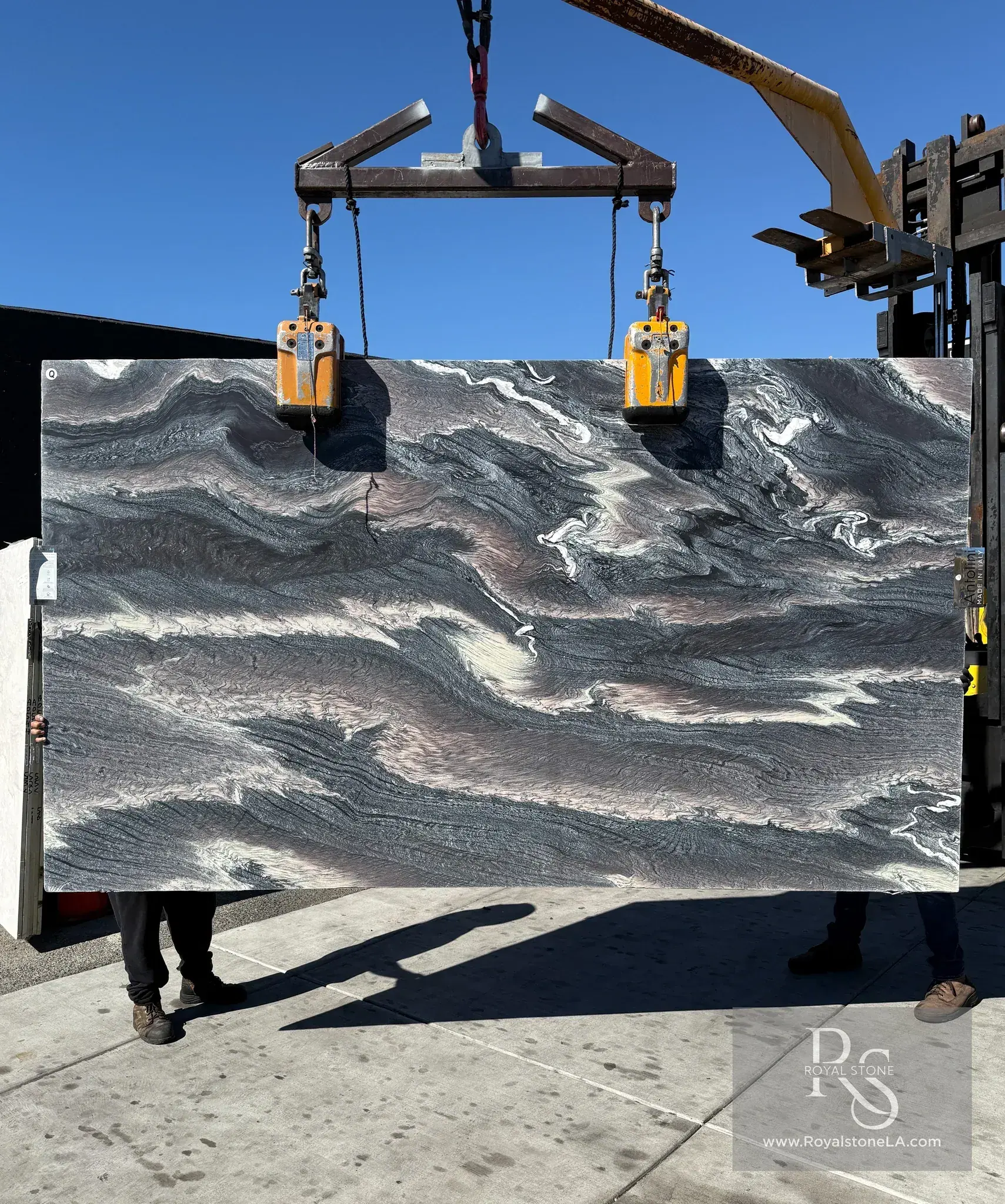 2cm Antolini Cipollino Ondulato marble slab, 69 by 121 inches, honed finish with horizontal undulating bands of charcoal, smoke gray, and dusty rose, lifted by crane at Royal Stone in Los Angeles