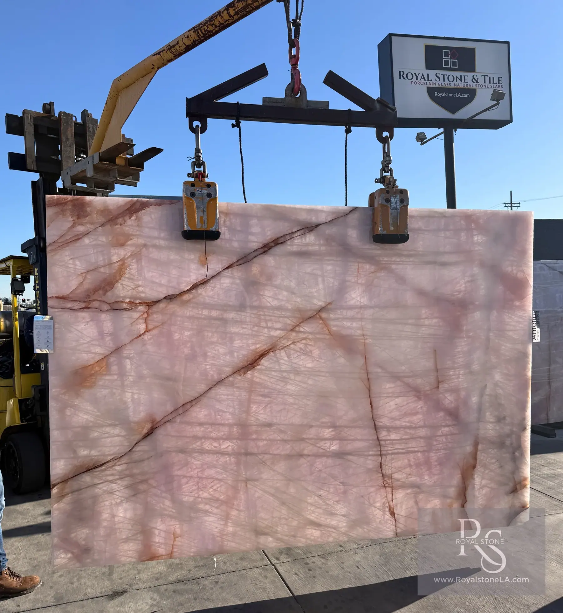 Antolini Cristallo Rosa pink quartzite slab backlit, copper veins glowing through the translucent blush field