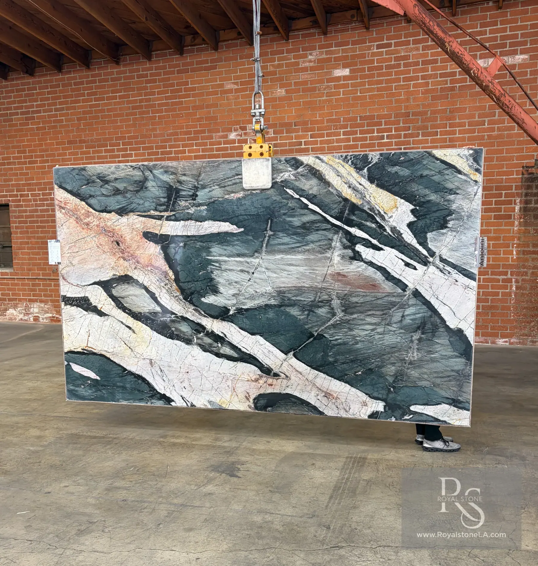 Antolini Green Savage quartzite slab YG674 polished at Royal Stone Los Angeles, deep forest green field with chalk-white quartz veins and amber accents, 78 by 129 inches