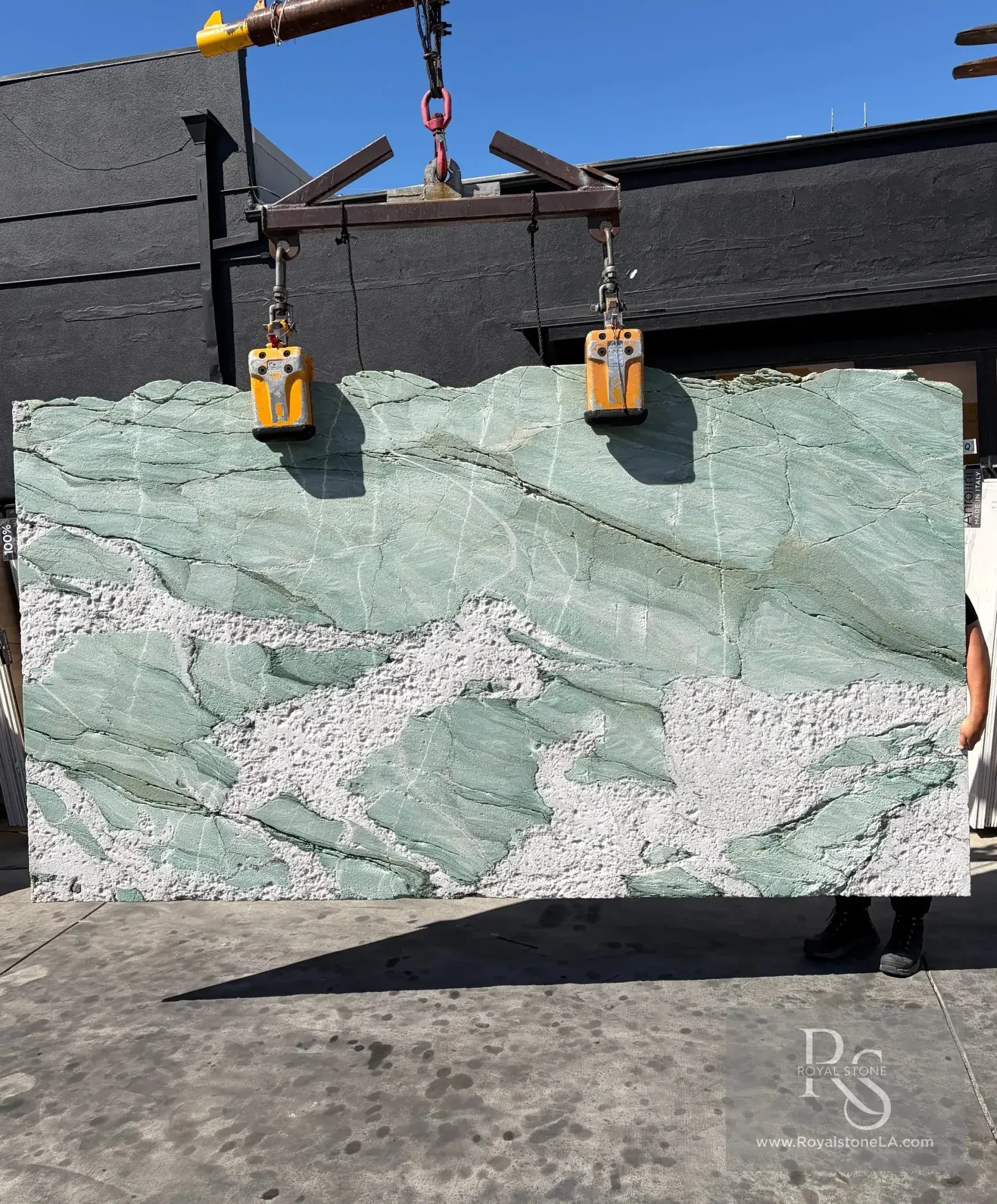 Antolini Hard Rock finish on Patagonia Aqua Green Cristallo quartzite slab at Royal Stone, deep sculpted texture