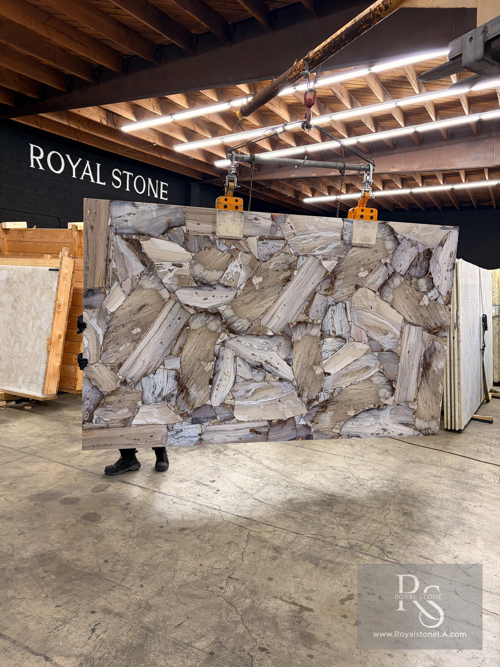 3cm Antolini Precious Stone Opal Agate slab, polished, 74 by 123 inches, natural agate slices in lavender grey and taupe, hanging from a crane at the Royal Stone Los Angeles warehouse