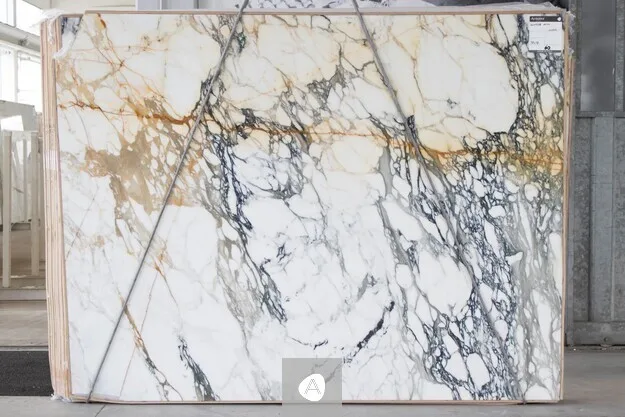 Antolini Paonazzo Antico marble slab with white field, charcoal veining, and warm gold-rust accents, polished finish