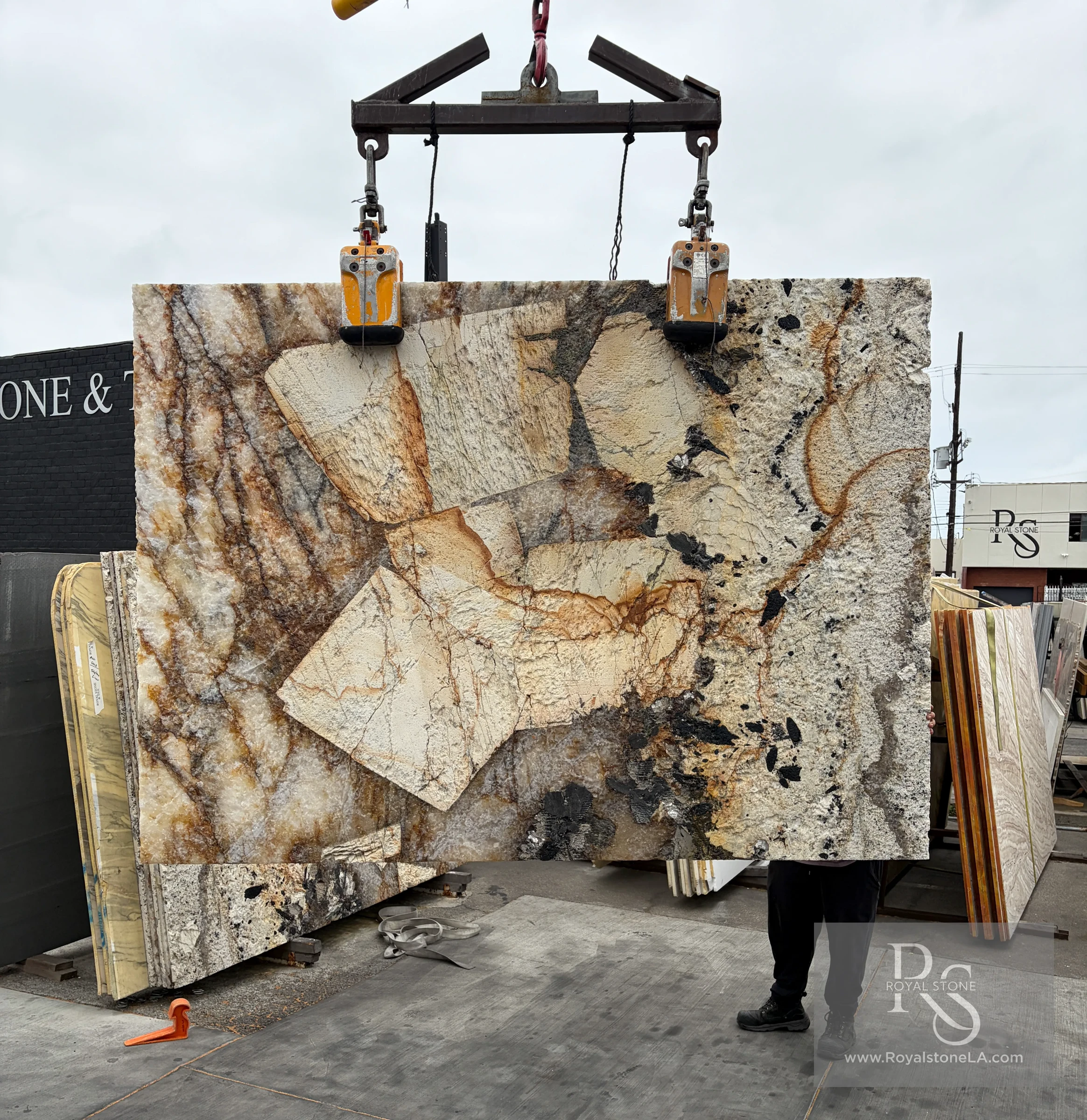 Antolini Patagonia Original quartzite slab in Hard Rock finish at Royal Stone Los Angeles, ivory and amber field with rust veining and deep sculpted surface relief