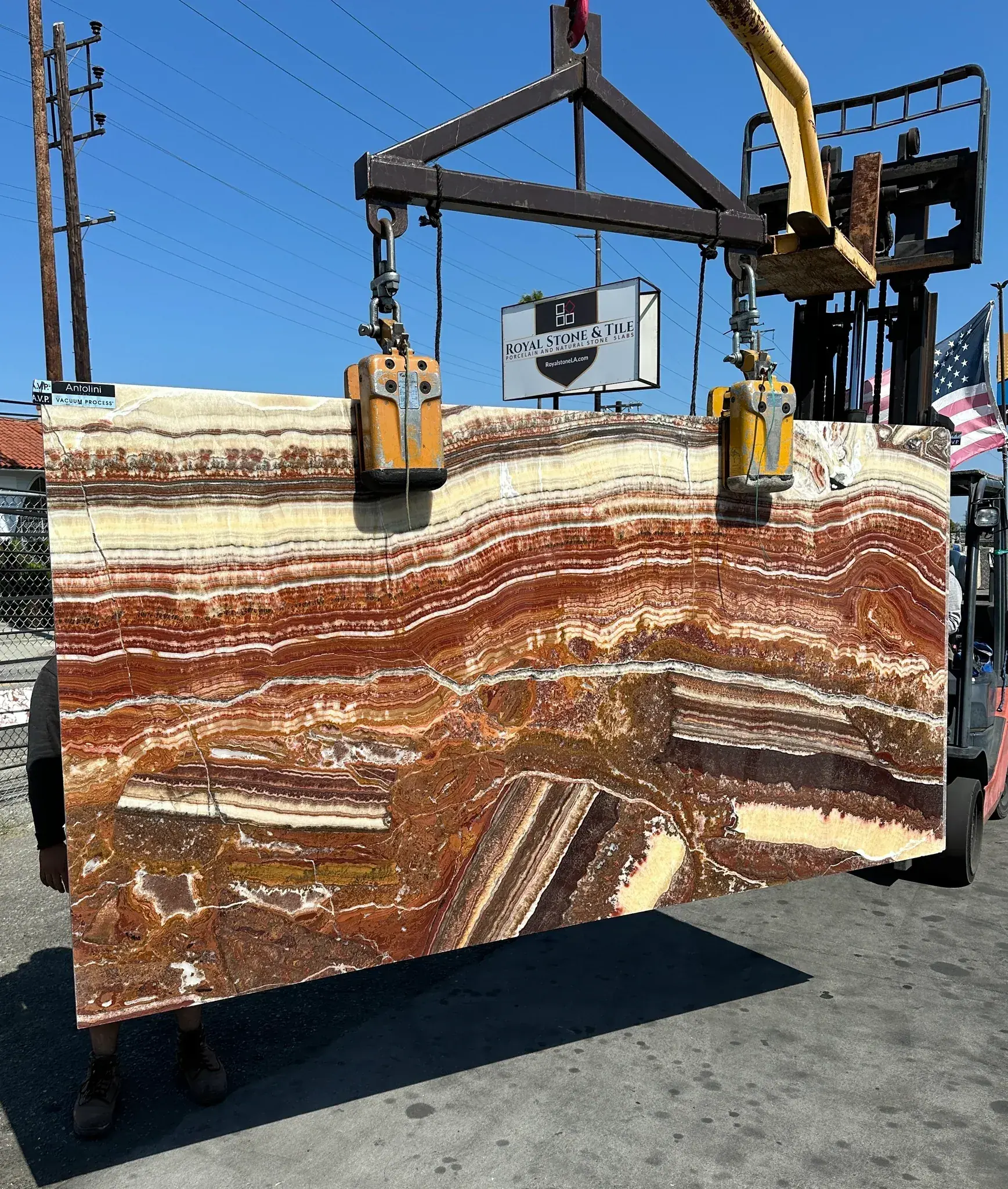 Antolini Red Onice Fantastico onyx slab polished at 56 by 110 inches at Royal Stone Los Angeles, saturated red and oxblood horizontal banding with amber and cream