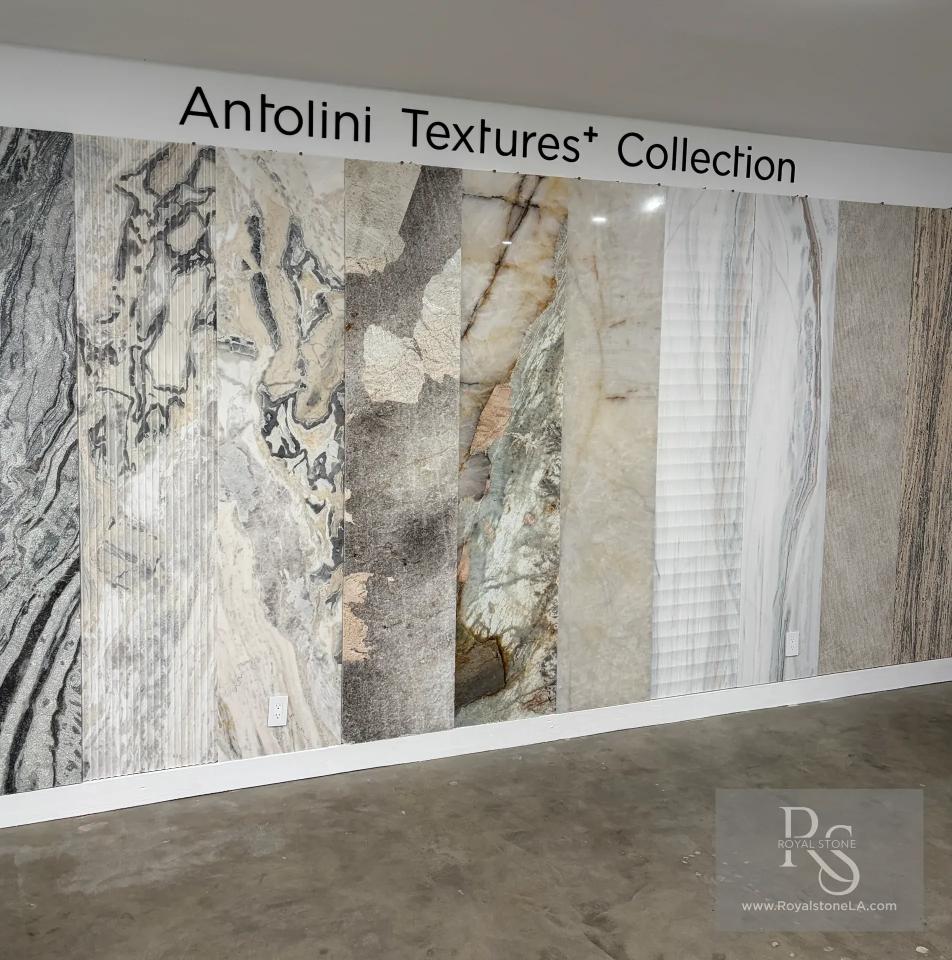 Antolini Textures+ Collection displayed at Royal Stone in Los Angeles, showing natural stone slabs with sculpted and linear surface finishes