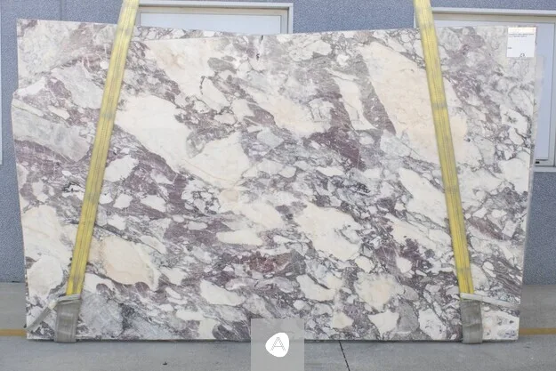 Calacatta Viola Antico Extra marble slab with warm cream ground laced with violet, plum, and amber breccia, polished finish
