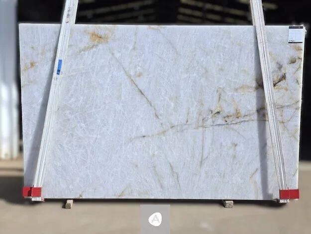 Antolini Cristallo Lumix quartzite slab with translucent white field shot with warm gold filaments, polished finish