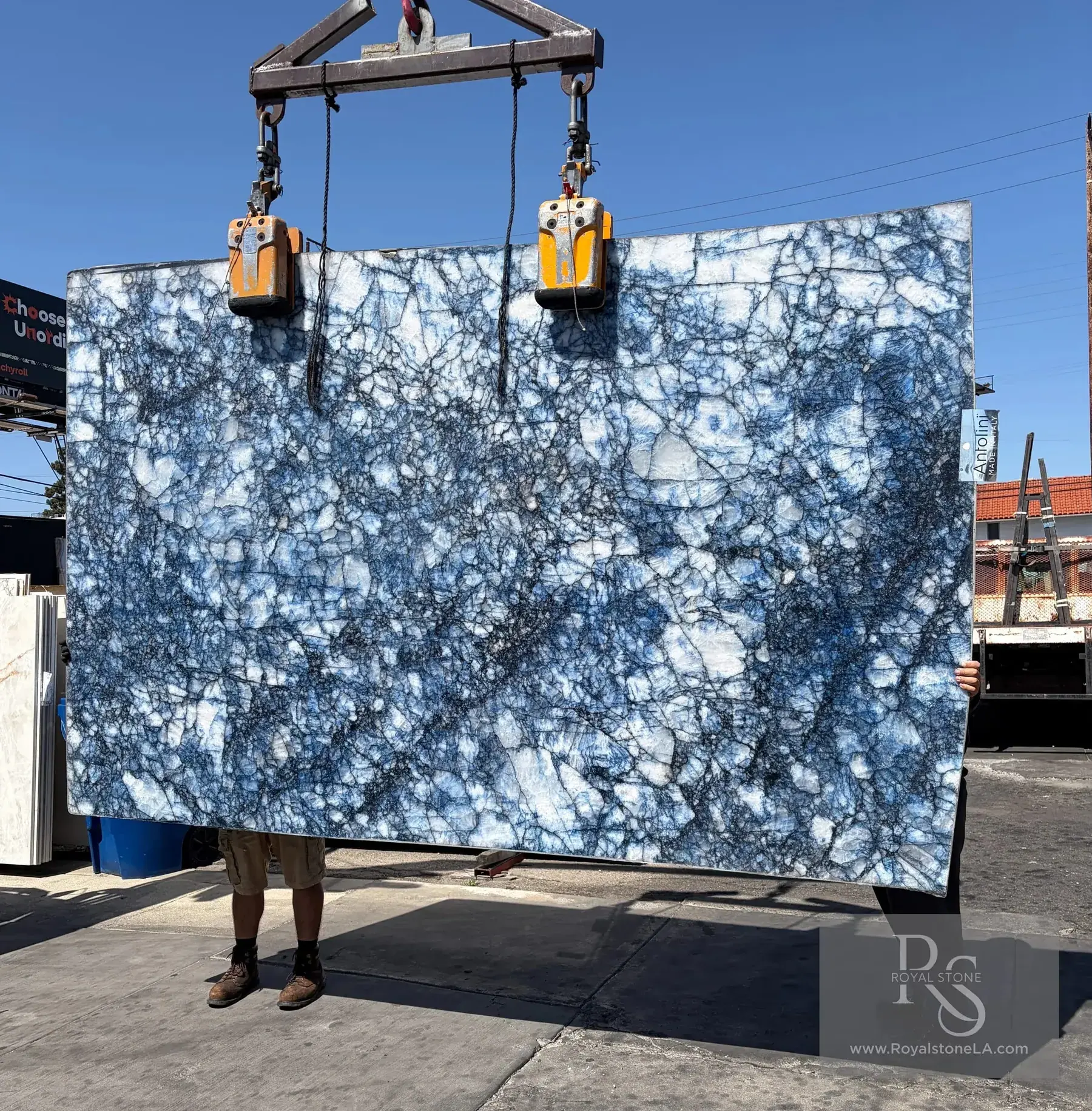 Antolini Cristallo Cobalt Blue Zaffiro polished translucent quartzite slab in daylight at Royal Stone, cobalt blue veining and iron threads on clear white crystalline field