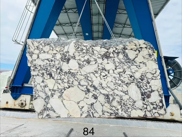 Raw block of Viola Calacatta marble, lot 84, freshly hoisted at the Italian quarry — one of the materials we walk and select by hand