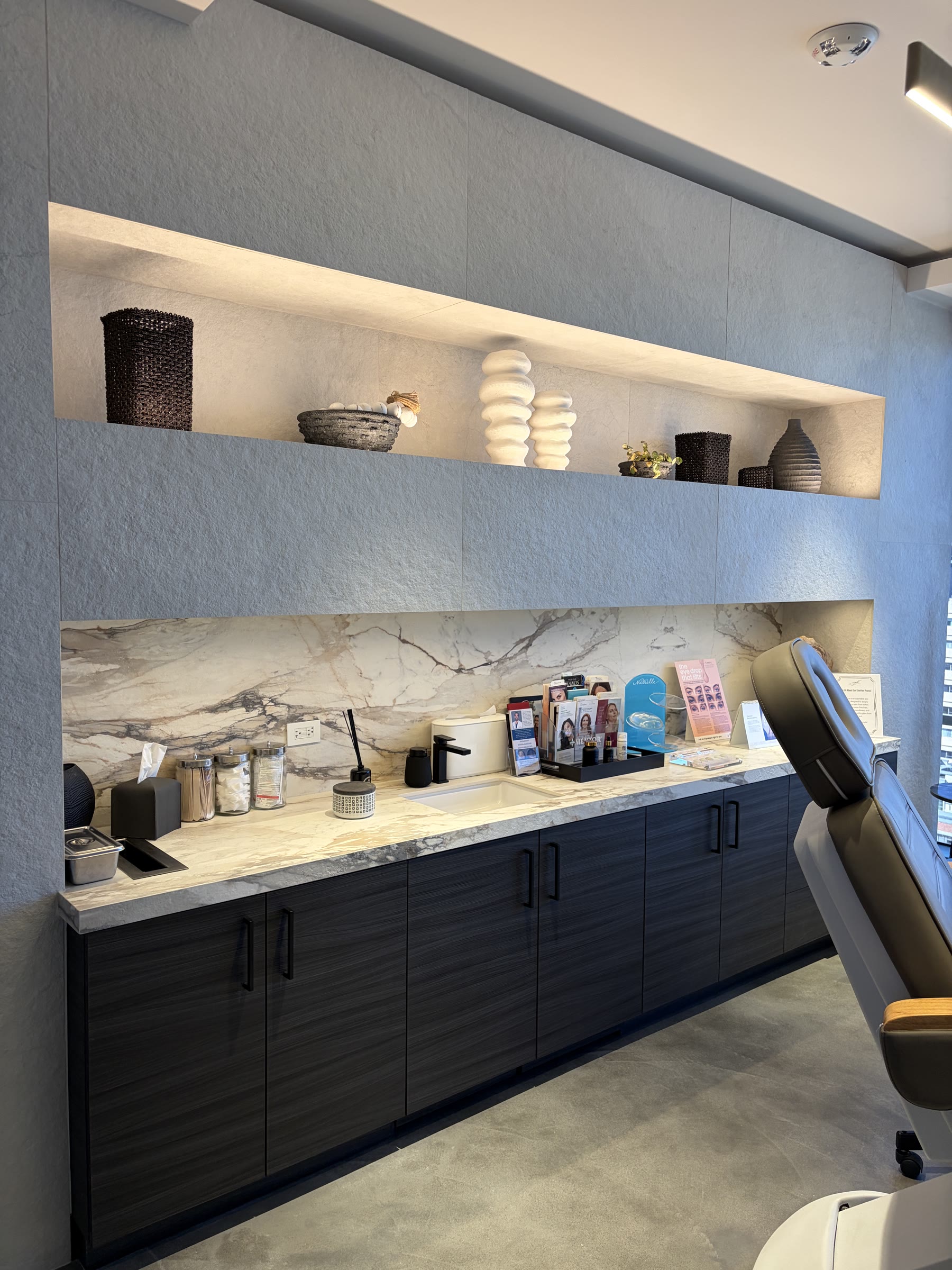 Marble-look porcelain wall, countertop, and built-in shelving in Jimmy S. Firouz, MD's Beverly Hills plastic surgery office